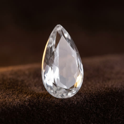 Colourless ash-crystal, faceted pear cut
